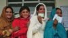 Female Pakistani voters pose with their national identity cards as they queue to cast their ballots at a polling station during the general elections in Rawalpindi. Women were warned by the Pakistani Taliban to stay home. (AFP/Farooq Naeem)