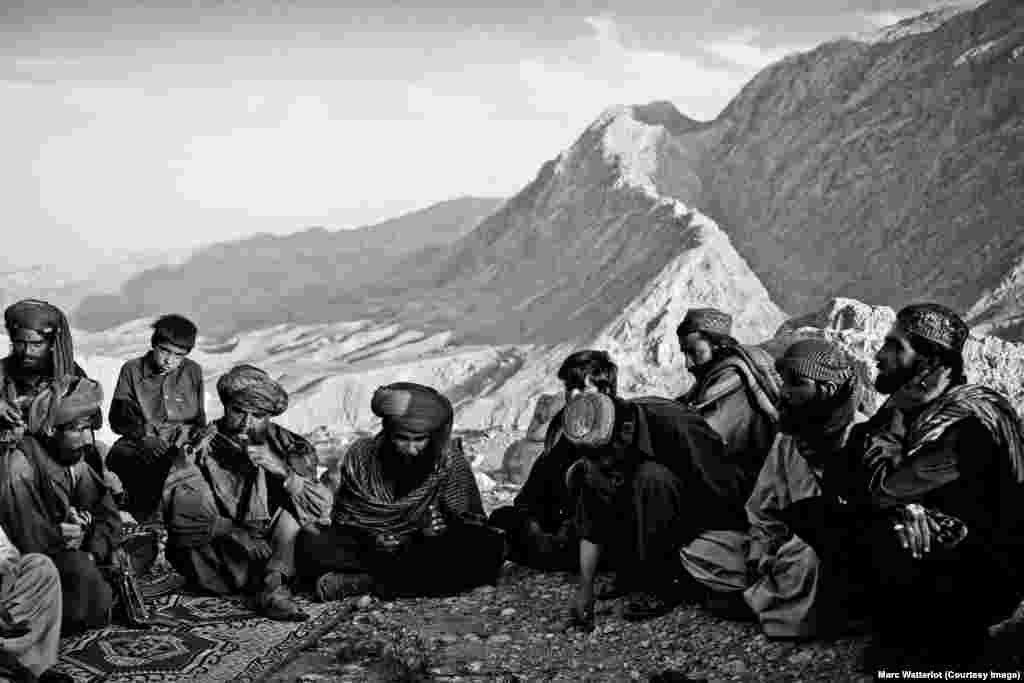 Residents from a nearby village visit a guerrilla encampment belonging to the Baloch Liberation Army.