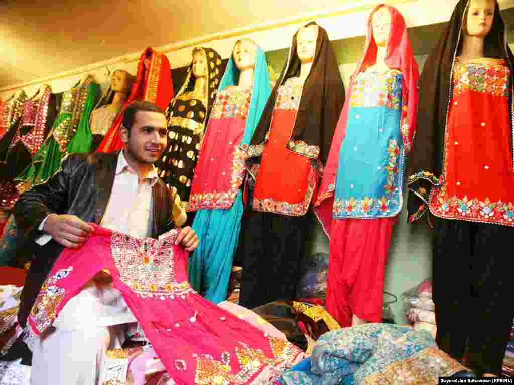 A shopkeeper waits on a customer at a Kabul market.