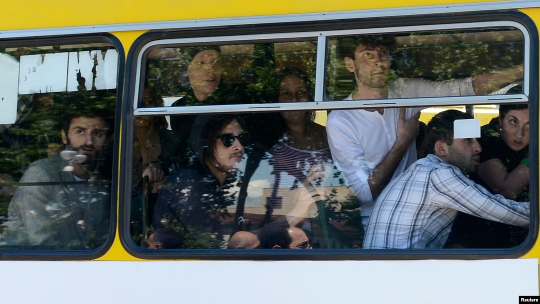 Gay-rights activists look out from a bus as they are evacuated by police during clashes in Tbilisi on May 17.
