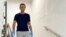 Russian opposition politician Alexei Navalny walks down stairs at Charite hospital in Berlin in an undated image obtained from social media.