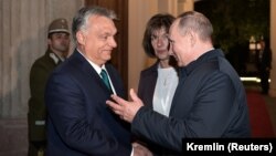 Hungarian Prime Minister Viktor Orban (left) shakes hands with Russian President Vladimir Putin during a meeting in Budapest in October 2019.