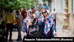 Iranian women walking in Ferdowsi street in Tehran, Iran, July 6, 2019. 