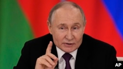 Russian President Vladimir Putin speaks to reporters following a meeting with Belarusian President Aleksandr Lukashenko at the Kremlin on March 13.