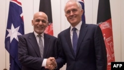Australian Prime Minister Malcolm Turnbull (R) poses with the visiting A fghan President Ashraf Ghani in Canberra on April 3, 2017.