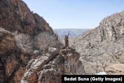 A member of the Organization of the Toilers of Kurdistan guards against drone attacks at a base in the mountains of Iraq's northeastern Erbil Province on March 12.