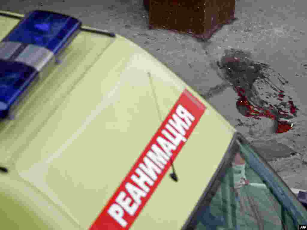 An ambulance near a puddle of blood at the Park Kultury metro station