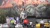 Iranians pass an anti-US billboard on Enghelab Square in Tehran on September 2.