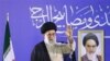 Current Supreme Leader Ayatollah Ali Khamenei flanked by a photo of his predecessor, Ruhollah Khomeini, in Mashhad in 2007