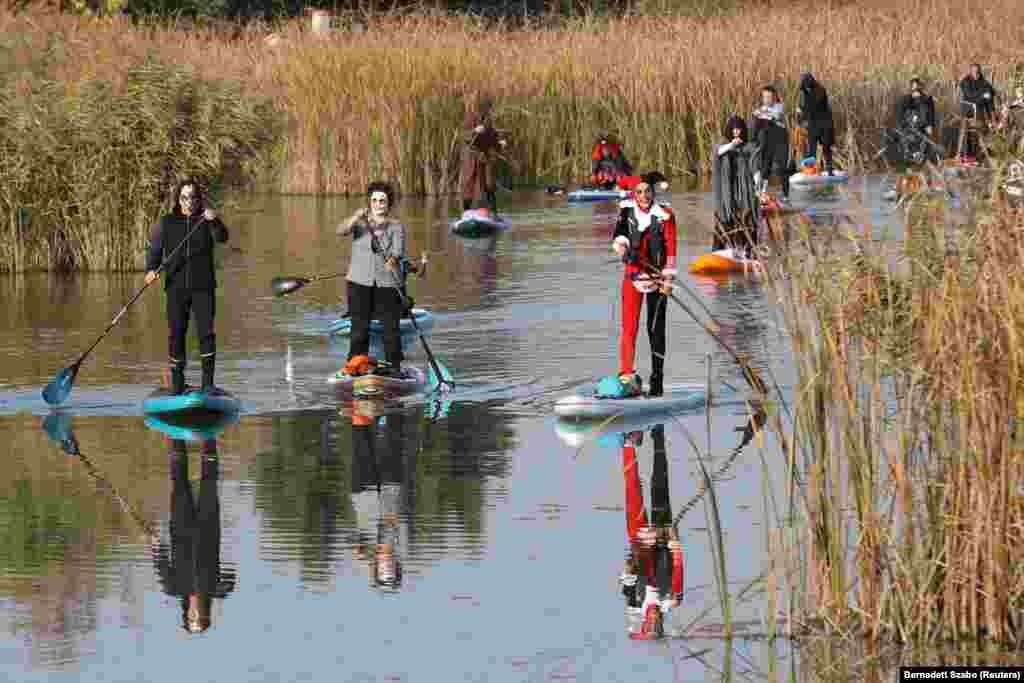 Participants make their way during a Halloween tour on the Rackevei-Duna, in Szigetszentmiklos, Hungary.