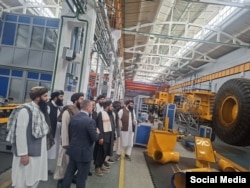 The Taliban delegation inside the BelAZ facility.