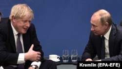 British Prime Minister Boris Johnson speaks with Russian President Vladimir Putin during the International Libya Conference in Berlin in January 2020.