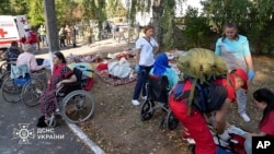 Elderly people are evacuated after a Russian strike hit a nursing home in Sumy on September 19.