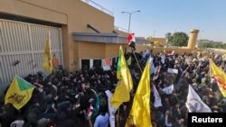 Iran-aligned militias protesting outside the U.S. embassy in Baghdad. Three days later, a U.S. drone fired missiles that killed Qassem Soleimani. December 31, 2019