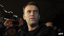 Anti-Kremlin blogger Aleksei Navalny speaks to journalists and supporters outside a police station in Moscow in December.