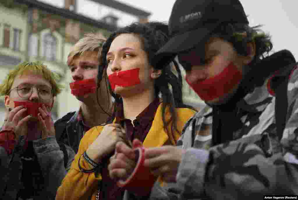 Activists of a local LGBT community put tape over their mouths as they protest against discrimination in St. Petersburg, Russia. (Reuters/Anton Vaganov)