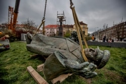 A monument to World War II Marshal Ivan Konev lies on the ground after being removed from its pedestal in Prague on April 3.