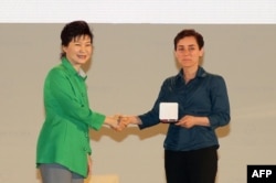 Мирзахани получает медаль из рук президента Южной Кореи Пак Кын Хе