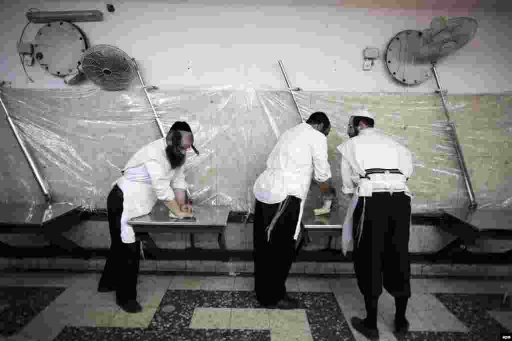 Ultraorthodox Jews knead dough in a Matzah Bakery in the Mea Shearim neighborhood of Jerusalem. (epa/Abir Sultan)