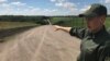 Ukrainian border guard Oksana Ivanets near the frontier fence with Russia in eastern Ukraine