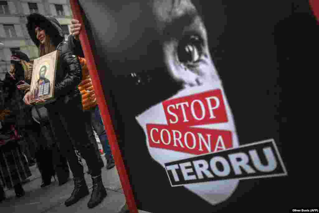 Serbian protesters take part in a demonstration against the restrictions implemented to limit the spread of COVID-19 in Belgrade. (AFP/Oliver Bunic)