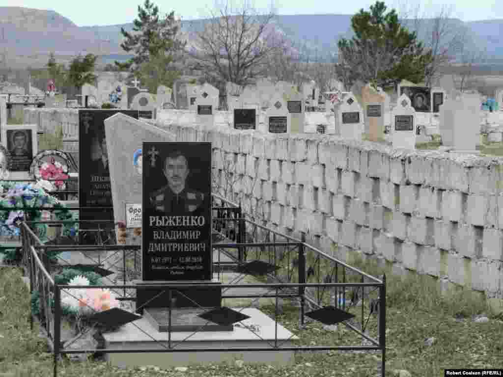 A cemetery outside Belogorsk with Christian graves on one side of wall and Muslim on the other.