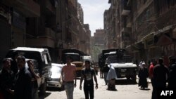 Egyptian security vehicles remain stationed in a poor area of the Qaliubia governorate, north of Cairo, following sectarian clashes between Christians and Muslims on April 6, which left five people dead. 