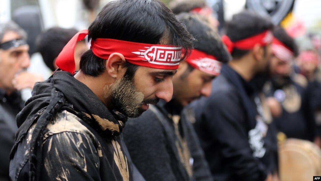 Iranian men cry during the Ashura commemorations that mark the killing of Imam Husayn, one of Shi'ite Islam's most revered figures, in Tehran in 2014.