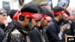 Iranian men cry during the Ashura commemorations that mark the killing of Imam Hussein, one of Shi'ite Islam's most revered figures, in Tehran on November 4. 