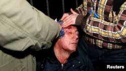 Opposition leader and former Interior Minister Yuriy Lutsenko receives medical aid after clashes with riot police near a court in Kyiv overnight on January 10-11.