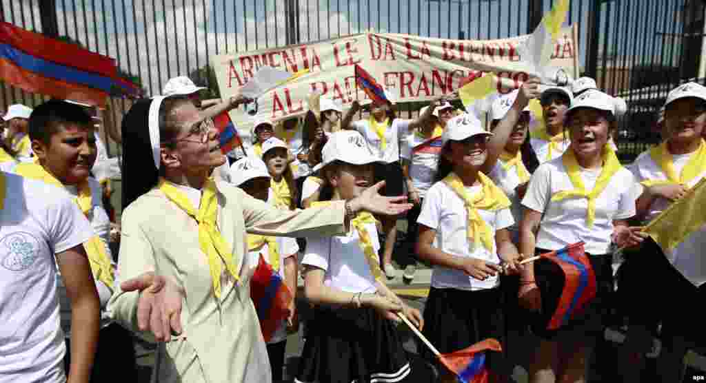 Armenia -- Young fans and supporters gather to welcome Pope Francis (not seen) as he arrives at Zvatnots International airport, Yerevan, June 24, 2016