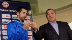 Armenia - Ruben Hayrapetian, chairman of the Football Federation of Armenia, hands an awards to Henrikh Mkhitaryan, the national football team captain, March 22, 2018.