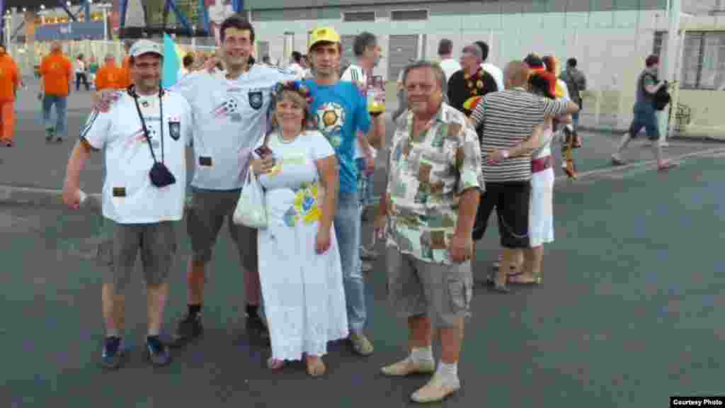 Toldina and Oleg pose with visiting German fans Thomas from Munich (left) and Volker from Berlin (second from left) who came for the Netherlands vs. Germany match on June 13. &quot;It was a pity that they had to go back home,&quot; Toldina said.