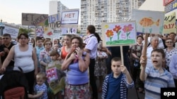 Residents of Moscow's Ramenki district hold posters with slogans such as 'No to killer road' as they protest against the decision of city authorities on a road separating residential areas and schools.