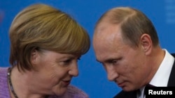 Germany's Chancellor Angela Merkel (left) and Russia's President Vladimir Putin attend a news conference after their meeting at the St. Petersburg International Economic Forum in June 2013.