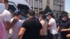 Police are shown detaining activists and their supporters in Shymkent on July 1.