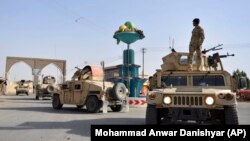 Afghan security personnel patrol in Ghazni on August 12. 