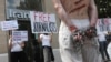 Activists from the press freedom watchdog Reporters Without Borders take part in a protest in front of an Iran Air office in Paris in July 2012.