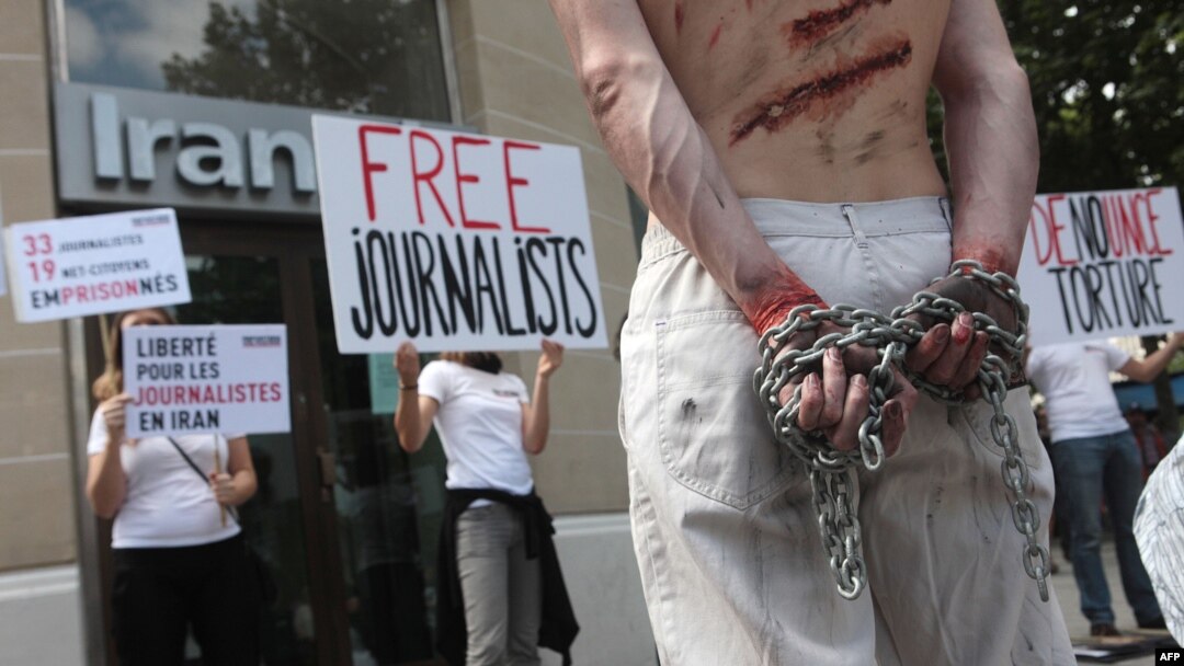 Activists from the press freedom watchdog Reporters Without Borders take part in a protest in front of an Iran Air office in Paris in July 2012.
