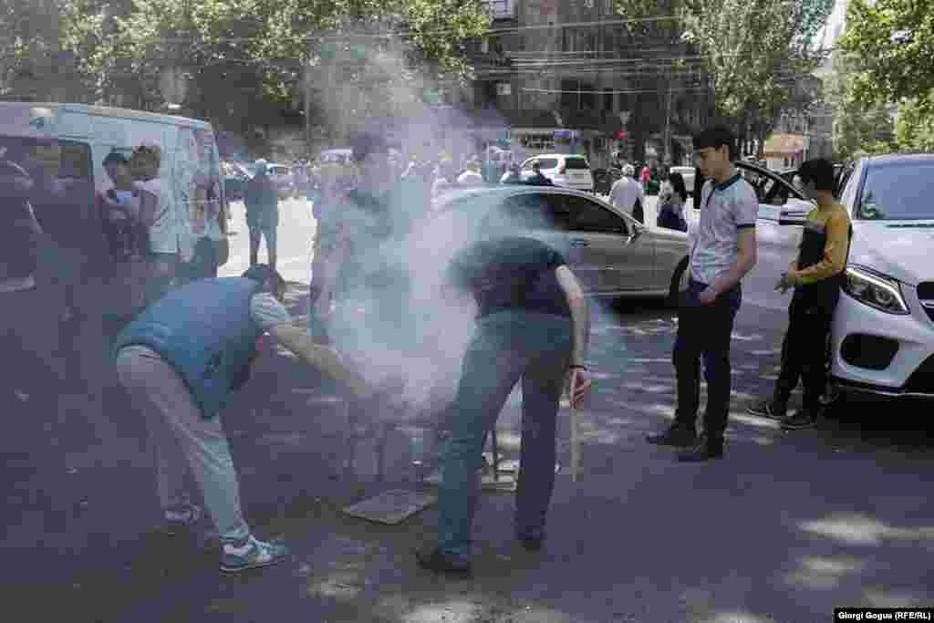 Protesters hold a barbecue on Yerevan&#39;s Shashlik Street. The general strike often took on a festive atmosphere.