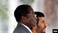 Iranian President Mahmud Ahmadinejad (right) with his Zimbabwean counterpart Robert Mugabe -- Tehran's last allies?