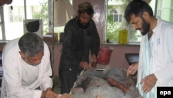 A civilian injured in U.S.-led coalition air strike receives treatment in Kandahar