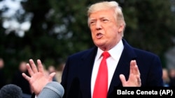 U.S. President Donald Trump speaks to reporters before leaving the White House on December 15.