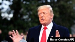 U.S. President Donald Trump speaks to reporters at the White House on December 15.