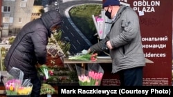 A customer buys a bouquet of tulips near a subway station in Kyiv. Somewhere along the line, calls for women’s rights and equality were eclipsed by gifts of greeting cards, bouquets, and sweets.