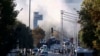 Smoke rises as emergency response teams and police officers attend the scene of an explosion at Turkish Aerospace Industries Inc. on the outskirts of Ankara on October 23. 