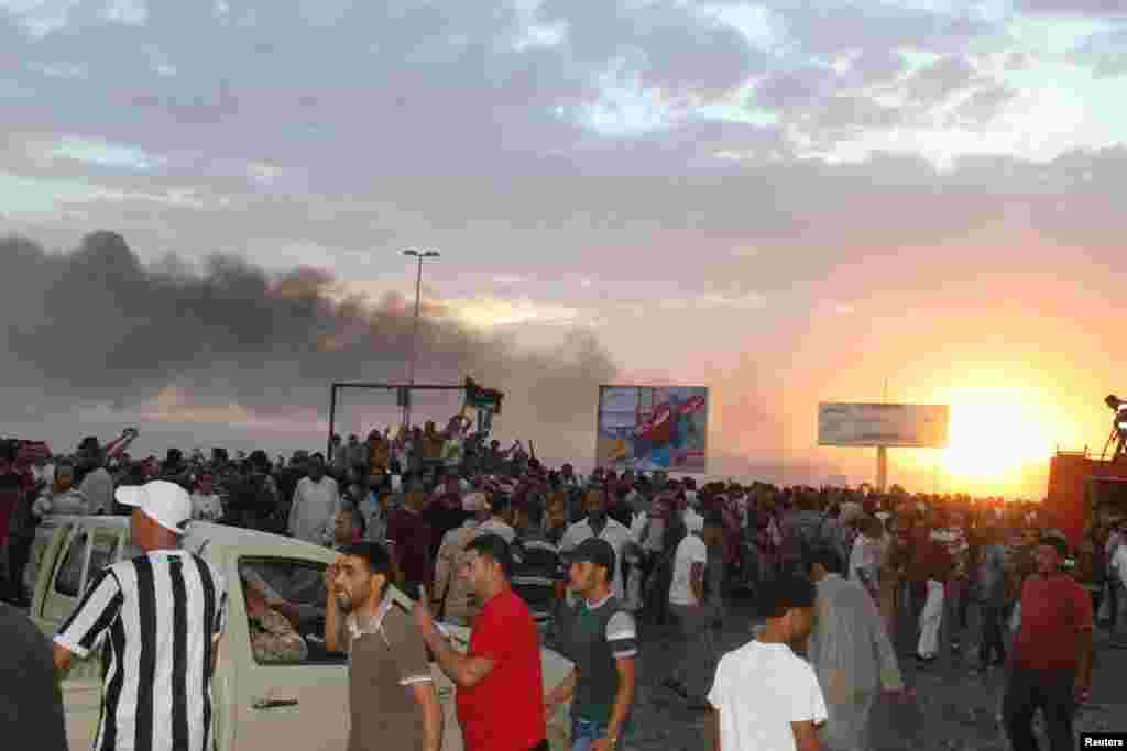 People gather at the scene of a Libyan warplane crash in the eastern city of Tobruk. (Reuters/Stringer)