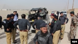 FILE: Police inspect the scene of a roadside bomb blast that their vehicle in Balochistan's capital, Quetta.