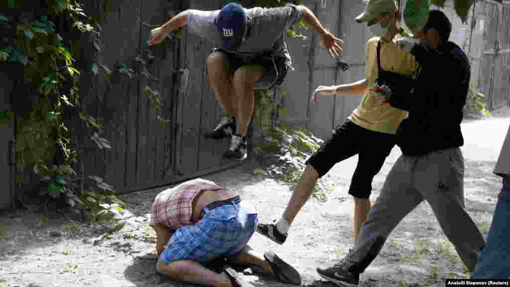 The head of the Gay Forum of Ukraine, Svyatoslav Sheremet, is savagely beaten by unknown assailants in Kyiv on May 20. (Reuters/Anatolii Stepanov)