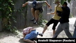 Nearby reporters captured the scene as unidentified assailants beat Svyatoslav Sheremet, the head of the Ukrainian Gay Forum, in Kyiv on May 20.